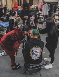 a group of people getting their hair done at a convention